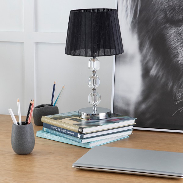 Table lamp sitting on stacked books